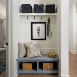 mudroom nook with hangers pillows and storage