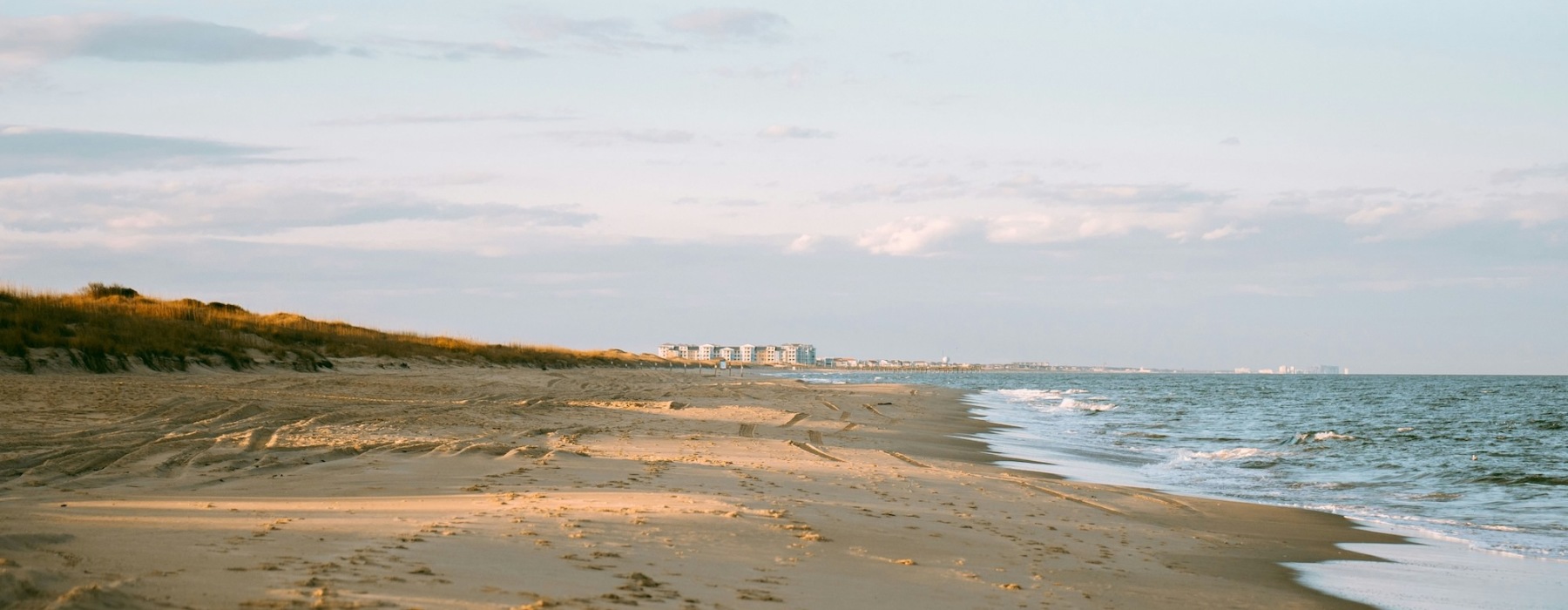 a beach near an ocean at sunrise
