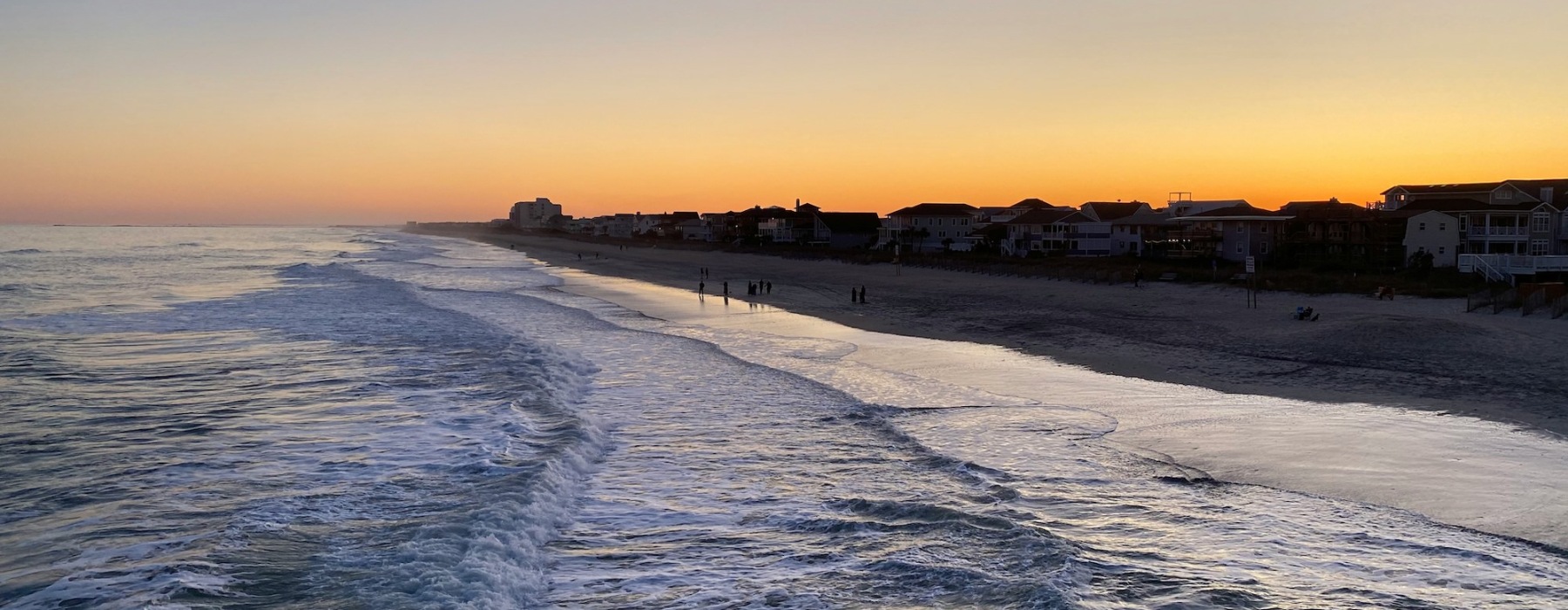 a ocean and beach at sunset