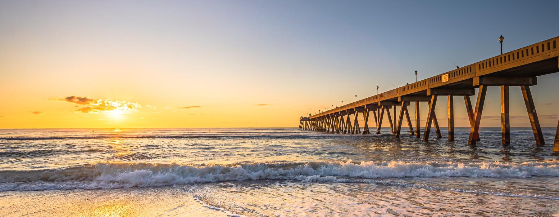 a long wooden pier over the ocean